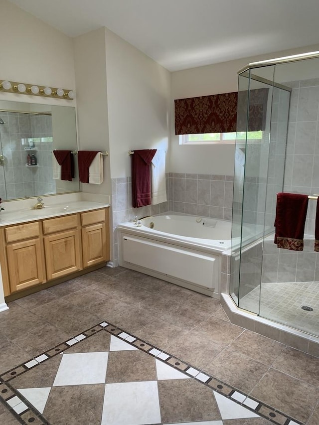 bathroom featuring a shower stall, vanity, and a bath