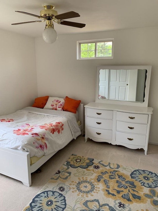 bedroom featuring light carpet and ceiling fan