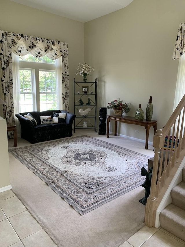 tiled living room featuring carpet and stairs