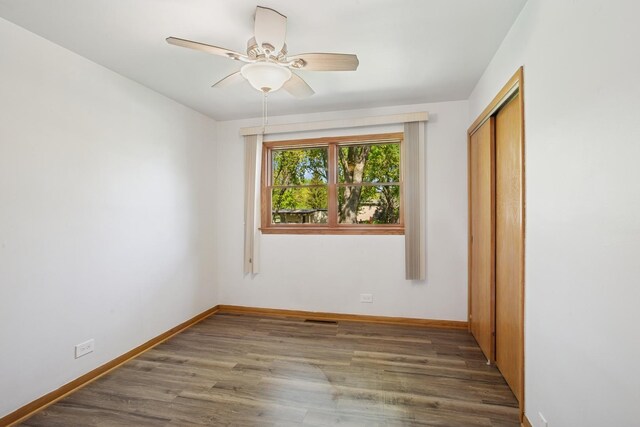 133 Maple Ct, Bloomingdale, IL 60108 - unfurnished bedroom with a closet, wood finished floors, baseboards, and a ceiling fan