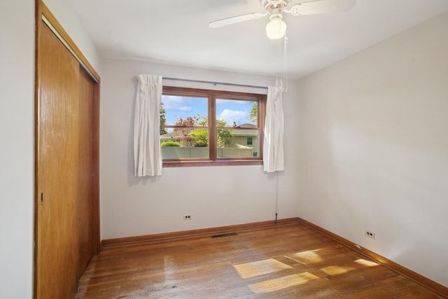 133 Maple Ct, Bloomingdale, IL 60108 - unfurnished bedroom with a closet, hardwood / wood-style flooring, baseboards, and a ceiling fan