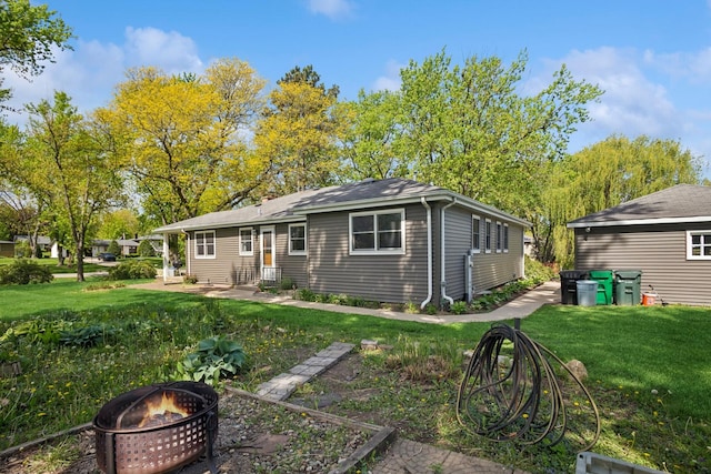 133 Maple Ct, Bloomingdale, IL 60108 - back of property with a fire pit, a yard, and entry steps