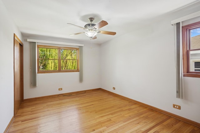 133 Maple Ct, Bloomingdale, IL 60108 - spare room featuring light wood-style flooring, ceiling fan, and baseboards