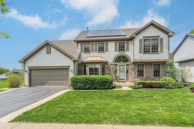 930 Ripple Brook Ln, Elgin, IL 60120 - view of front of property with asphalt driveway, a front yard, roof with shingles, and a garage