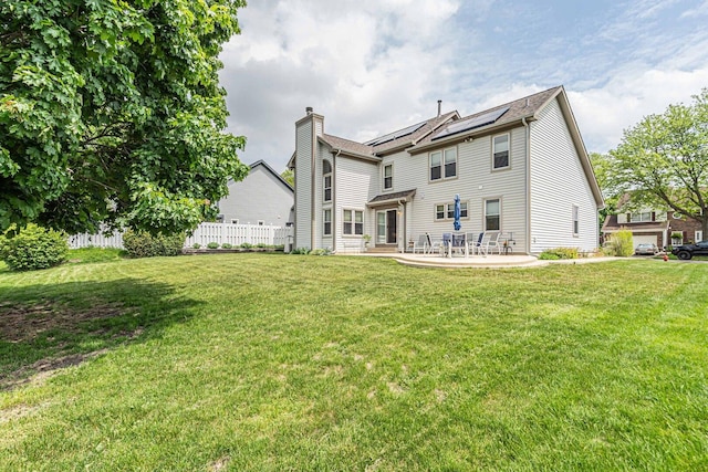 930 Ripple Brook Ln, Elgin, IL 60120 - rear view of property with solar panels, a patio, and a chimney