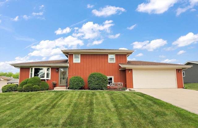 tri-level home with an attached garage, driveway, and a front yard