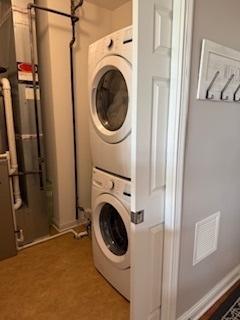 140 S River St Unit 208, Aurora, IL 60506 - clothes washing area with stacked washer and clothes dryer and baseboards