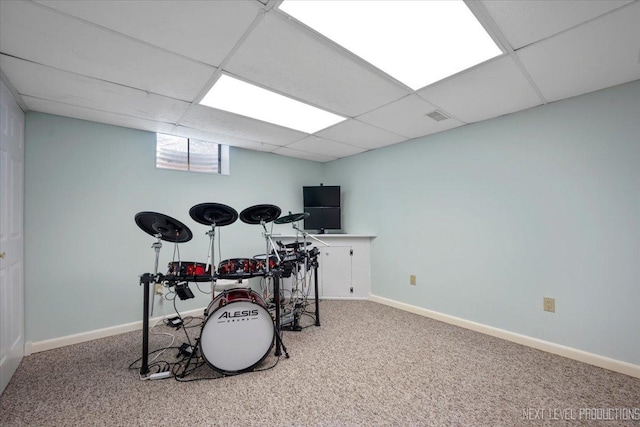 rec room with carpet floors, a paneled ceiling, and baseboards