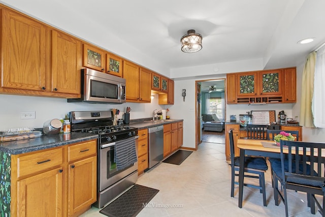 16810 Highview Ave, Orland Hills, IL 60487 - kitchen featuring appliances with stainless steel finishes, a sink, dark countertops, ceiling fan, and brown cabinetry