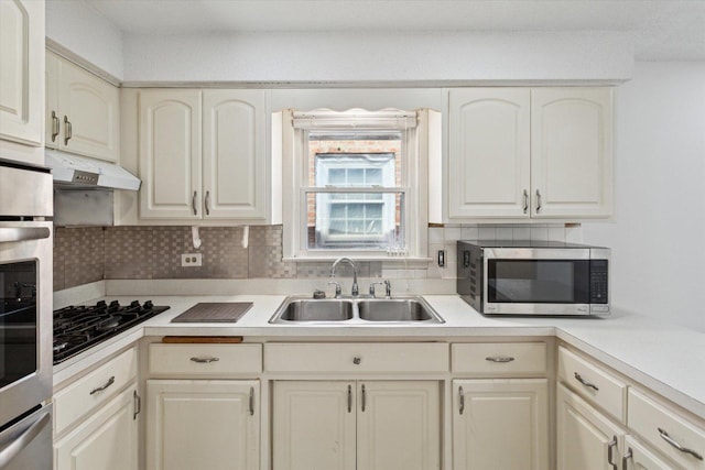 1230 W 112th Pl, Chicago, IL 60643 - kitchen with stainless steel appliances, a sink, under cabinet range hood, backsplash, and light countertops