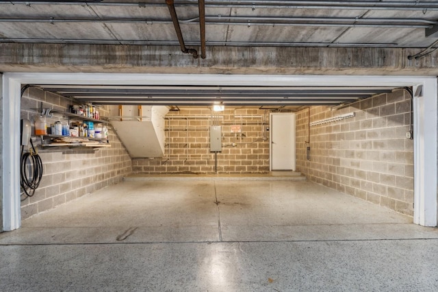 garage with concrete block wall