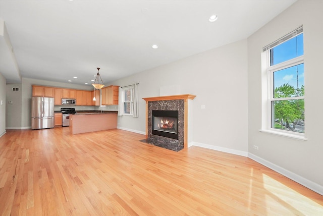 6640 S Kimbark Ave Unit 3, Chicago, IL 60637 - unfurnished living room featuring light wood-style floors, baseboards, a premium fireplace, and recessed lighting