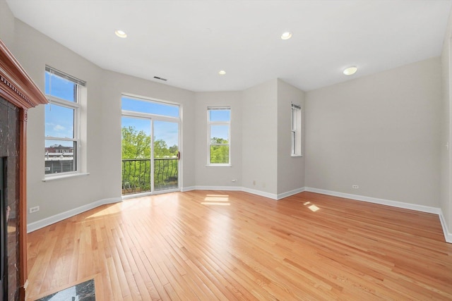 6640 S Kimbark Ave Unit 3, Chicago, IL 60637 - unfurnished room with light wood finished floors, baseboards, healthy amount of natural light, a fireplace, and recessed lighting