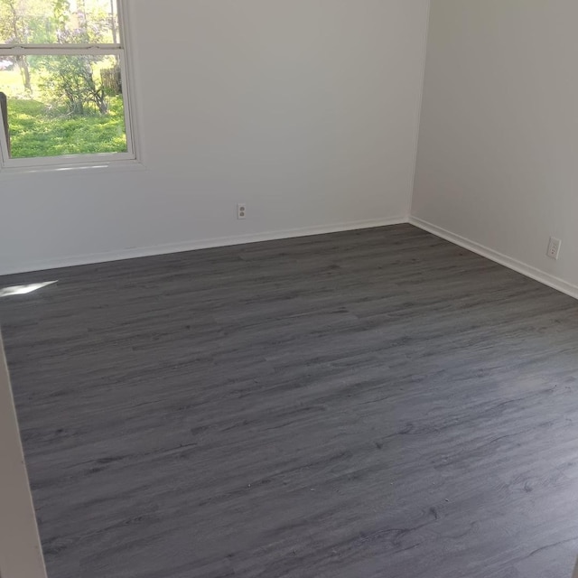 430 Spring Ave, Dekalb, IL 60115 - unfurnished room with baseboards and dark wood-style floors