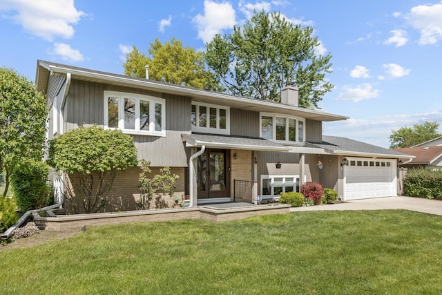 50 Kendal Rd, Elk Grove Village, IL 60007 - view of front of home with brick siding, a chimney, driveway, an attached garage, and a front yard