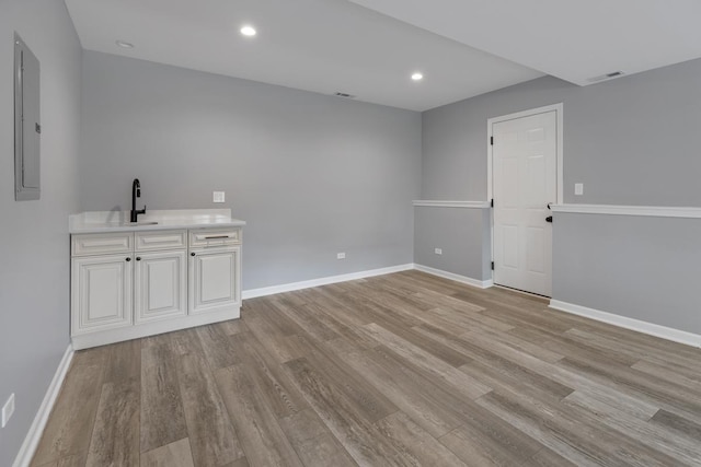50 Kendal Rd, Elk Grove Village, IL 60007 - empty room featuring light wood-type flooring, a sink, baseboards, and recessed lighting