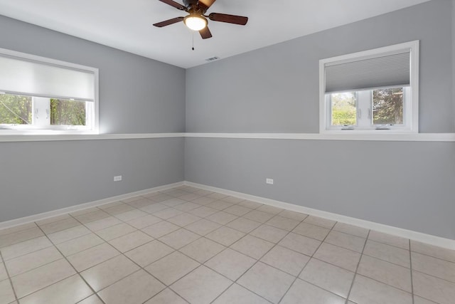 50 Kendal Rd, Elk Grove Village, IL 60007 - unfurnished room featuring plenty of natural light, ceiling fan, baseboards, and light tile patterned floors