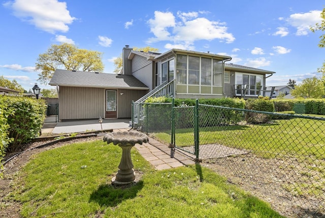 50 Kendal Rd, Elk Grove Village, IL 60007 - back of house with a sunroom, a gate, a chimney, and a patio area
