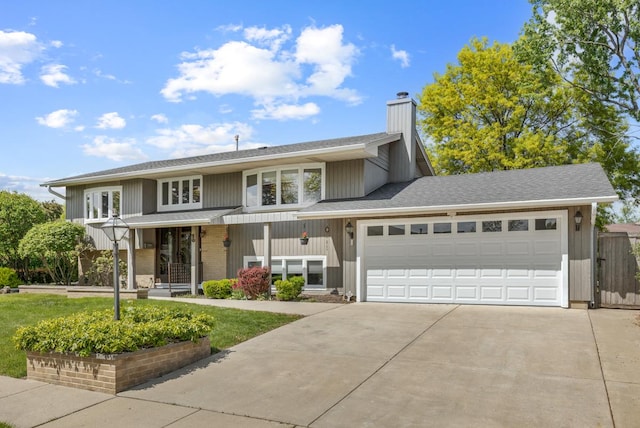50 Kendal Rd, Elk Grove Village, IL 60007 - view of front of property with driveway, a chimney, an attached garage, and covered porch