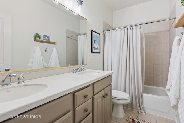 bathroom with toilet, double vanity, tile patterned flooring, and shower / bath combo