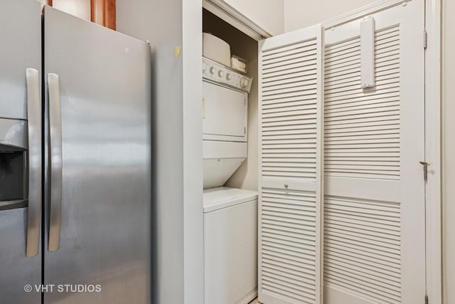 washroom featuring stacked washer and clothes dryer