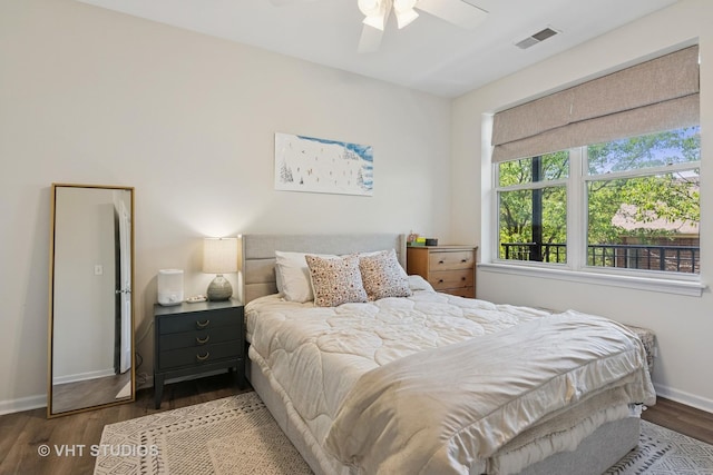 bedroom with wood finished floors, baseboards, and ceiling fan