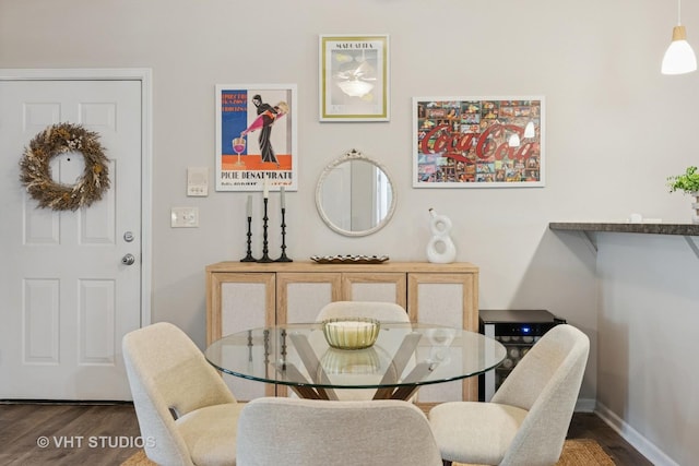 dining area featuring wood finished floors and baseboards