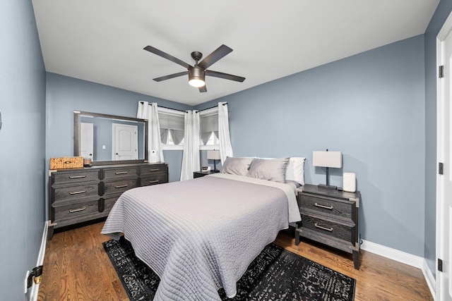bedroom featuring baseboards, dark wood-style flooring, and a ceiling fan