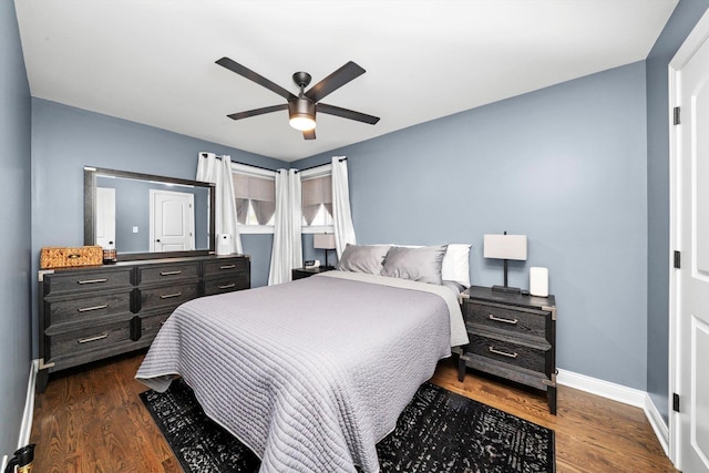 bedroom featuring baseboards, dark wood finished floors, and a ceiling fan