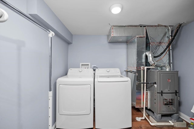 washroom with separate washer and dryer and wood finished floors