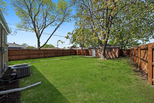 view of yard with central AC, a shed, and an outdoor structure