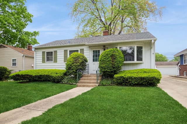 814 Hollywood Ave, Des Plaines, IL 60016 - view of front facade with a chimney, a front yard, board and batten siding, and a detached garage