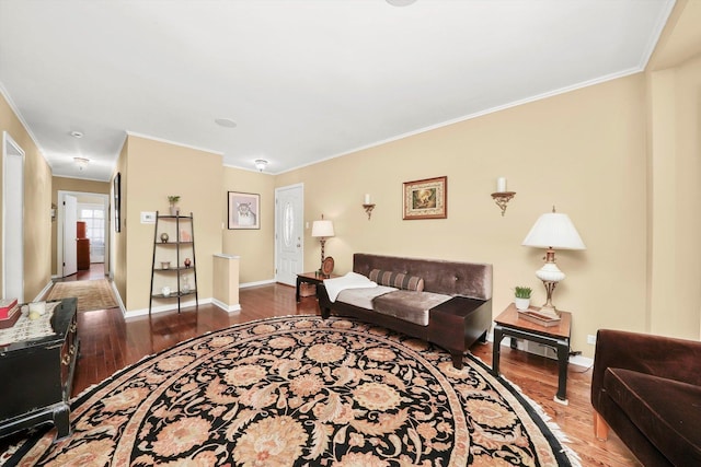 living area with wood finished floors, crown molding, and baseboards