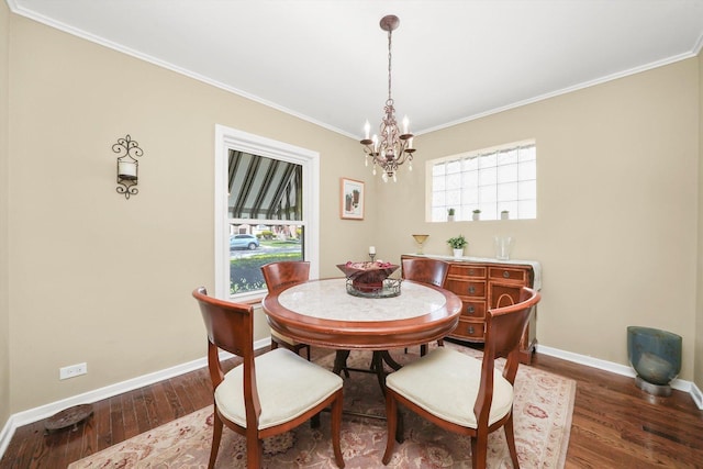 dining area with a chandelier, crown molding, wood finished floors, and baseboards