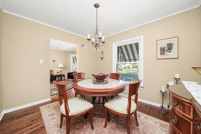dining space featuring wood finished floors, baseboards, a chandelier, and ornamental molding