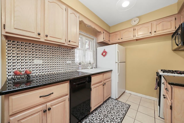 kitchen with black appliances, dark countertops, light brown cabinetry, and decorative backsplash