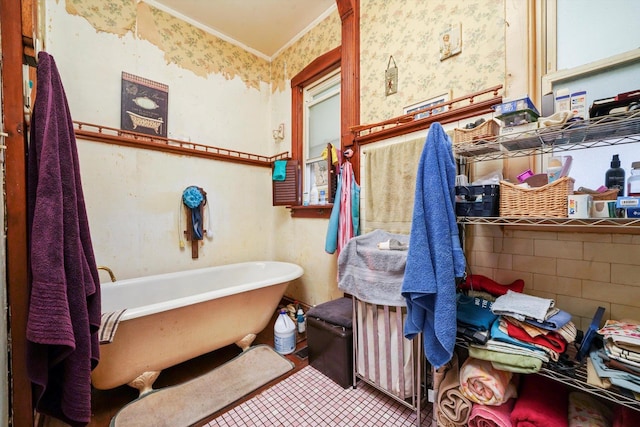 3732 Wisconsin Ave, Berwyn, IL 60402 - bathroom featuring wallpapered walls, a freestanding tub, tile patterned floors, and crown molding