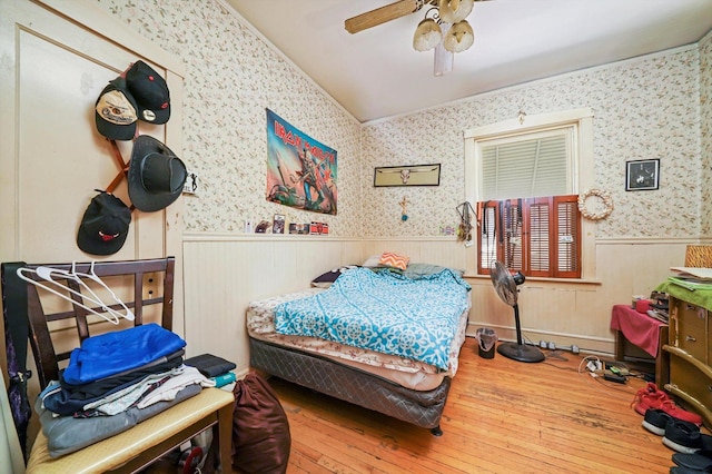 3732 Wisconsin Ave, Berwyn, IL 60402 - bedroom with wainscoting, wood-type flooring, wallpapered walls, vaulted ceiling, and ceiling fan