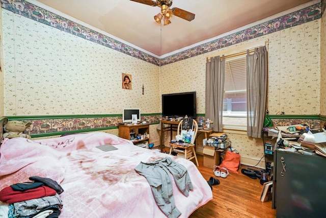 3732 Wisconsin Ave, Berwyn, IL 60402 - bedroom featuring wallpapered walls, wood finished floors, crown molding, and a ceiling fan