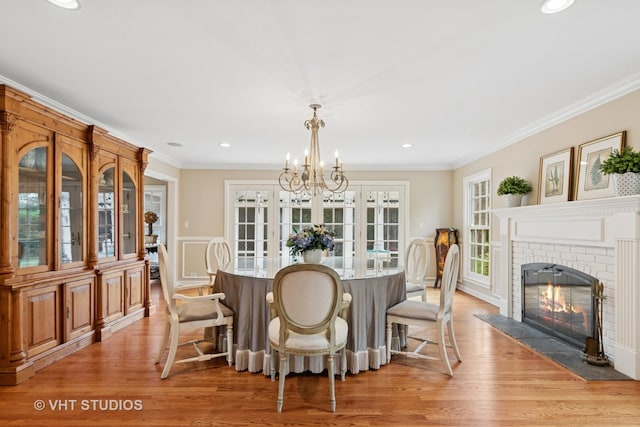 11 Longmeadow Rd, Winnetka, IL 60093 - dining room featuring light wood finished floors, ornamental molding, a brick fireplace, a chandelier, and recessed lighting