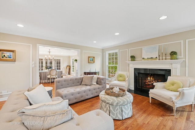 11 Longmeadow Rd, Winnetka, IL 60093 - living area with a chandelier, ornamental molding, light wood-style flooring, a premium fireplace, and recessed lighting