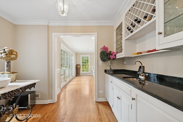 11 Longmeadow Rd, Winnetka, IL 60093 - kitchen with ornamental molding, baseboards, light wood-style floors, white cabinetry, and glass insert cabinets