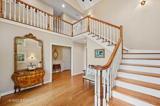 11 Longmeadow Rd, Winnetka, IL 60093 - staircase with wood finished floors, high vaulted ceiling, baseboards, and recessed lighting