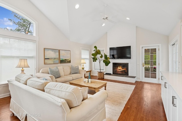 11 Longmeadow Rd, Winnetka, IL 60093 - living room featuring high vaulted ceiling, a large fireplace, plenty of natural light, dark wood-type flooring, and ceiling fan