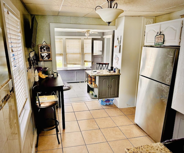1258 Perry St, Des Plaines, IL 60016 - kitchen with freestanding refrigerator, light tile patterned flooring, open shelves, ceiling fan, and light countertops