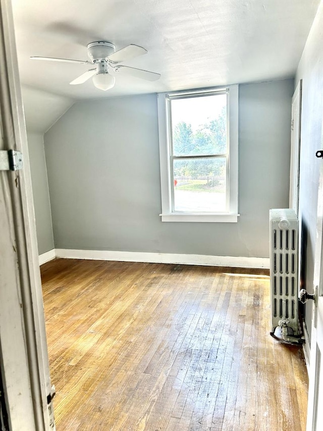 1258 Perry St, Des Plaines, IL 60016 - bonus room featuring radiator heating unit, wood-type flooring, a ceiling fan, and lofted ceiling