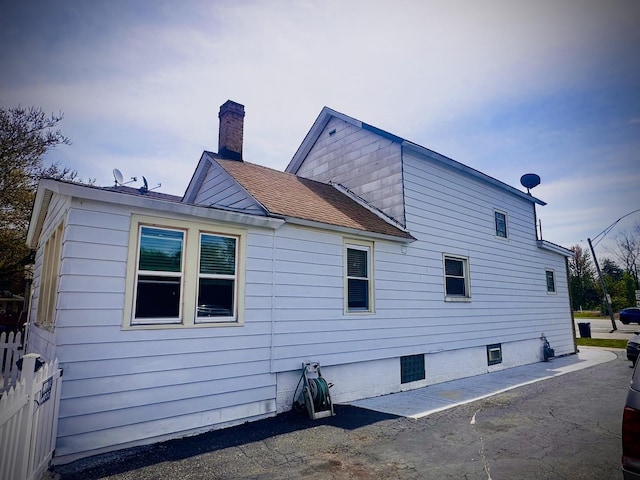 1258 Perry St, Des Plaines, IL 60016 - view of side of property with a chimney, fence, and a shingled roof