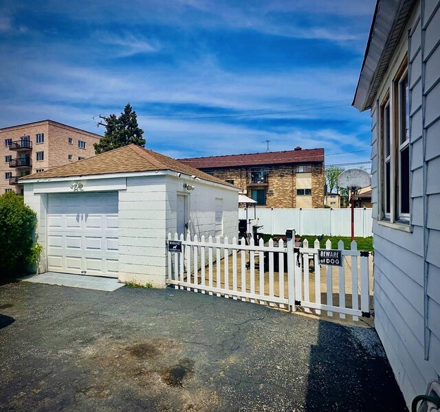 1258 Perry St, Des Plaines, IL 60016 - view of yard with an outbuilding, fence, a garage, and driveway