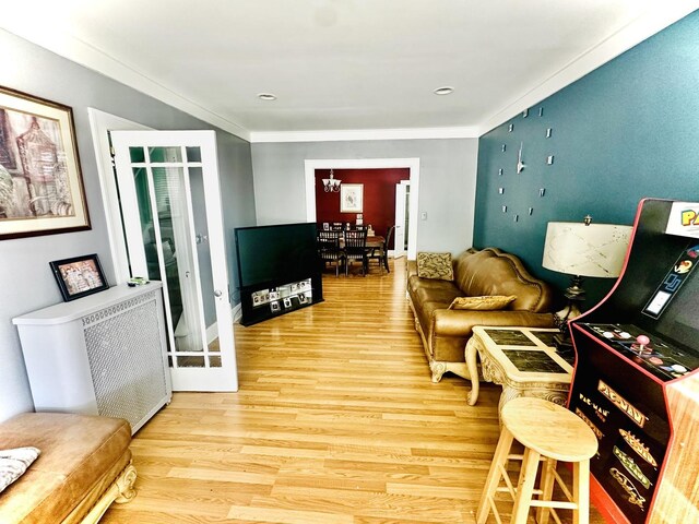 1258 Perry St, Des Plaines, IL 60016 - living area featuring wood finished floors, a chandelier, ornamental molding, and radiator