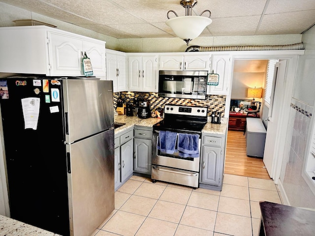 1258 Perry St, Des Plaines, IL 60016 - kitchen with appliances with stainless steel finishes, gray cabinetry, light tile patterned floors, white cabinetry, and decorative backsplash
